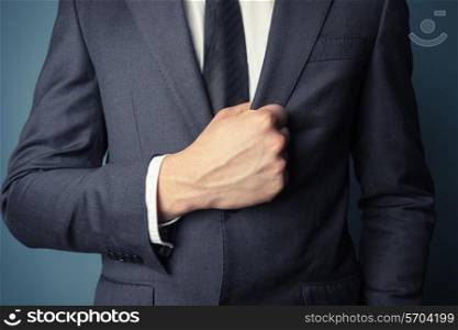 Closeup on a businessman grabbing his suit jacket