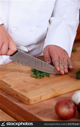 Closeup on a chef cutting parsley
