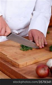 Closeup on a chef cutting parsley