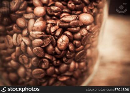 Closeup on a glass jar with coffee beans