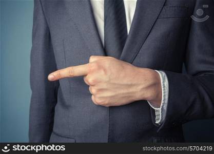 Closeup on a young businessman pointing left