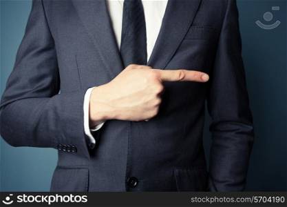 Closeup on a young businessman pointing right