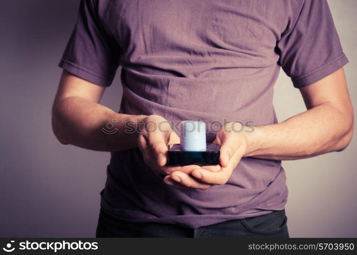 Closeup on a young man holding a small candle