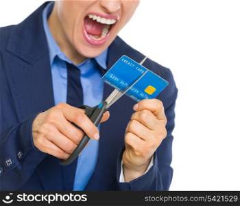 Closeup on angry business woman cutting credit card with scissors