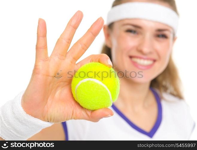 Closeup on ball in hand of smiling tennis player