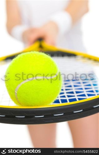 Closeup on ball on racket in hand of tennis player