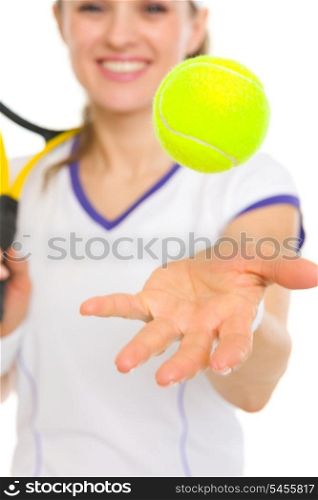 Closeup on ball throwing up in air by tennis player