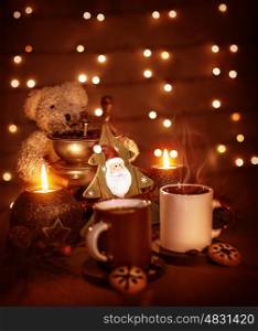 Closeup on beautiful Christmastime still life, coffee cups with tasty cookies, teddy bear and decorative wooden tree on glowing background