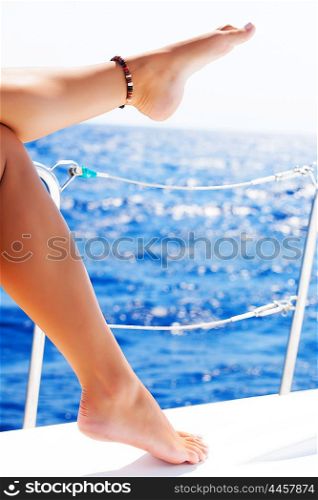Closeup on beautiful sexy women&rsquo;s feet on the yacht, body part, journey on sailboat, summer vacation, conceptual image of pleasure and enjoyment