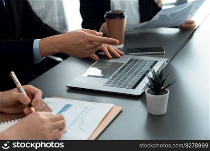 Closeup on BI dashboard on meeting desk with businesspeople analyzing or planning business strategy with hands pointing on financial paper reports as concept of harmony in office workplace.