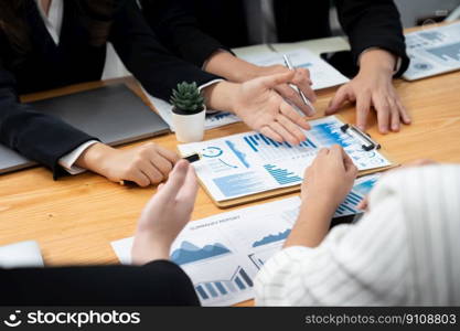 Closeup on BI dashboard on meeting desk with businesspeople analyzing or planning business strategy with hands pointing on financial paper reports as concept of harmony in office workplace.. Closeup focus on BI dashboard with office worker in harmony office.