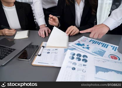 Closeup on BI dashboard on meeting desk with businesspeople analyzing or planning business strategy with hands pointing on financial paper reports as concept of harmony in office workplace.. Closeup focus on BI dashboard with office worker in harmony office.