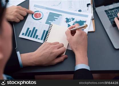 Closeup on BI dashboard on meeting desk with businesspeople analyzing or planning business strategy with hands pointing on financial paper reports as concept of harmony in office workplace.. Closeup focus on BI dashboard with office worker in harmony office.