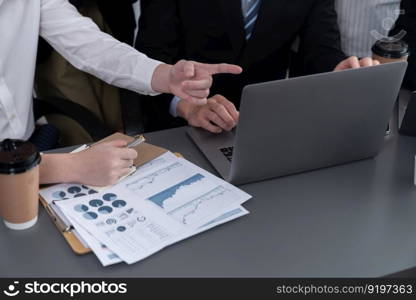 Closeup on BI dashboard on meeting desk with businesspeople analyzing or planning business strategy with hands pointing on financial paper reports as concept of harmony in office workplace.. Closeup focus on BI dashboard with office worker in harmony office.