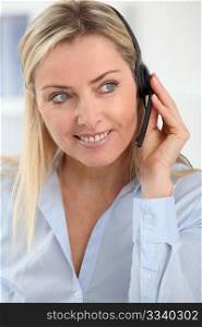 Closeup on blond woman with headset on