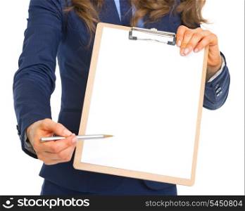 Closeup on business woman giving clipboard for sign