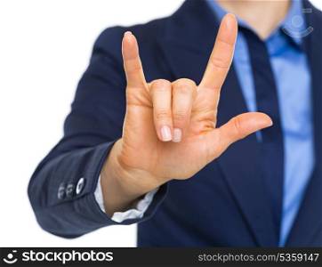 Closeup on business woman showing l love you gesture