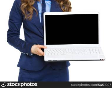 Closeup on business woman showing laptop blank screen