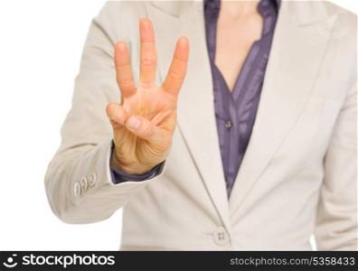 Closeup on business woman showing three with fingers