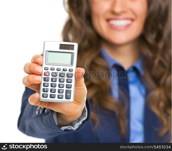 Closeup on calculator in hand of smiling business woman