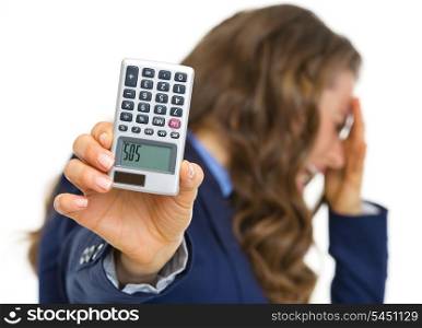Closeup on calculator with sos inscription in hand of frustrated business woman