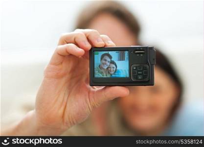 Closeup on camera making portrait of young couple