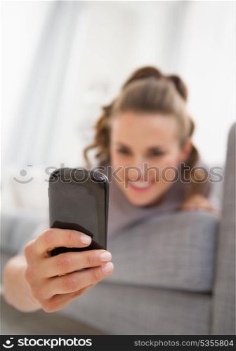 Closeup on cell phone in hand of young woman reading sms