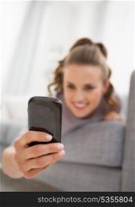 Closeup on cell phone in hand of young woman reading sms