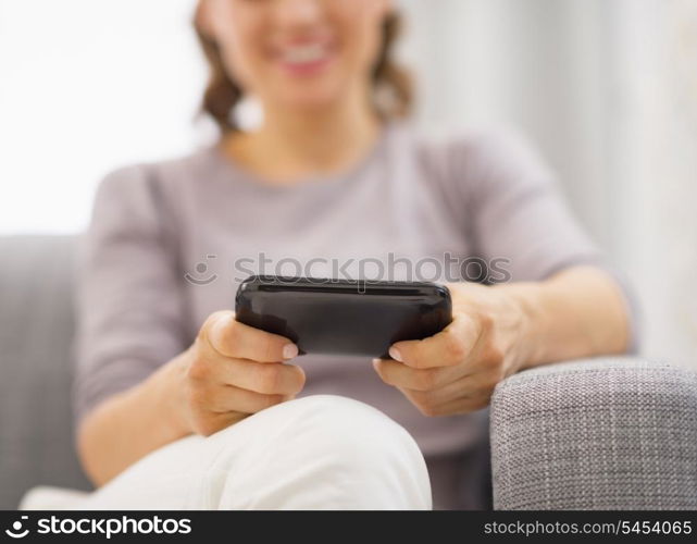 Closeup on cell phone in hand of young woman writing sms