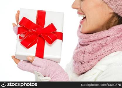 Closeup on Christmas present box in hand of woman in winter clothing