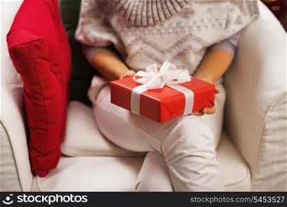 Closeup on christmas present box in hand of young woman