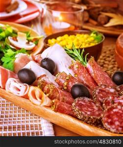 Closeup on cold cuts in centerpiece of table, various of smoked meat, bacon, beef, ham, pepperoni, salamy, restaurant menu