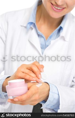 Closeup on cosmetologist woman applying creme