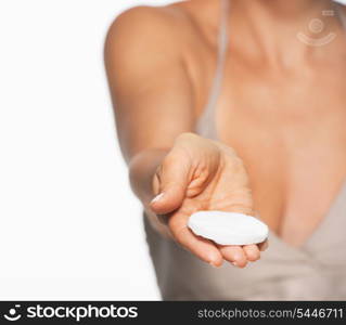 Closeup on cotton pad in hand of woman