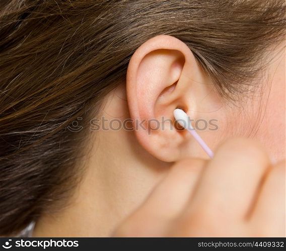 Closeup on cotton swabs in hand of woman