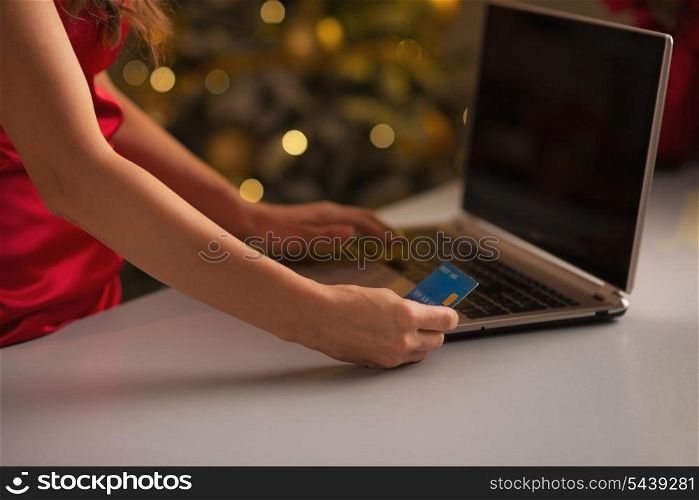 Closeup on credit card in hand of woman making online christmas purchases
