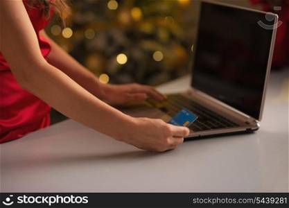 Closeup on credit card in hand of woman making online christmas purchases