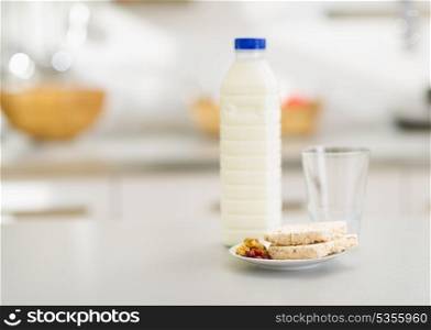 Closeup on crisp bread and milk on table in kitchen