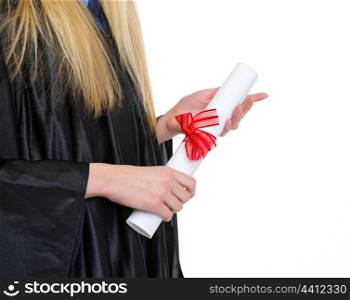 Closeup on diploma in hand of woman in graduation gown