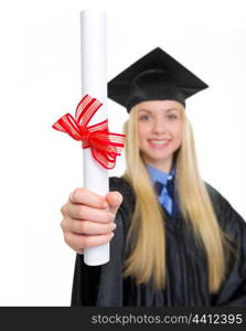 Closeup on diploma in hand of young woman in graduation gown