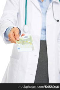 Closeup on doctor woman giving euros