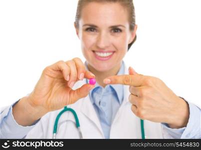 Closeup on doctor woman pointing on pill