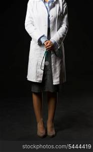 Closeup on doctor woman with stethoscope isolated on black