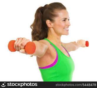 Closeup on dumbbell in hand of fitness young woman