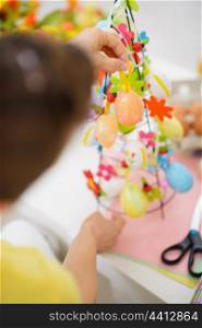 Closeup on female hands making Easter decoration