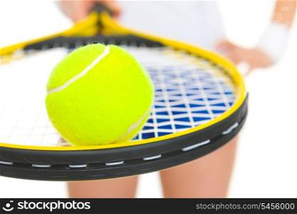 Closeup on female tennis player holding racket with ball