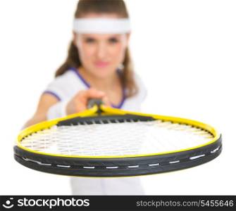 Closeup on female tennis player pointing racket in camera