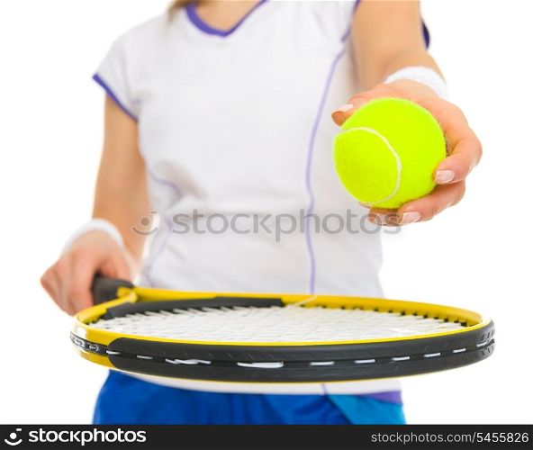 Closeup on female tennis player with racket and ball
