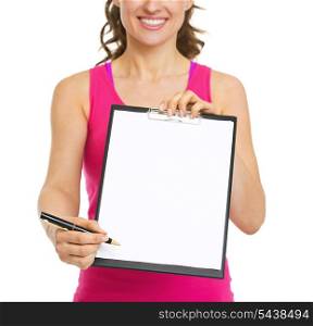 Closeup on fitness trainer giving clipboard for sign