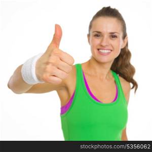 Closeup on fitness young woman showing thumbs up